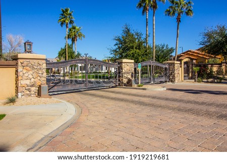 Double Access Gates With Large Palm Trees