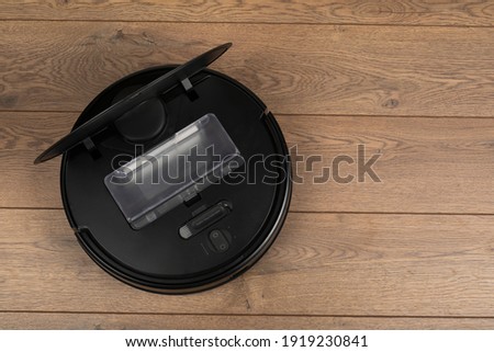 Picture of an automatic intelligent robotic vacuum cleaner  on the floor