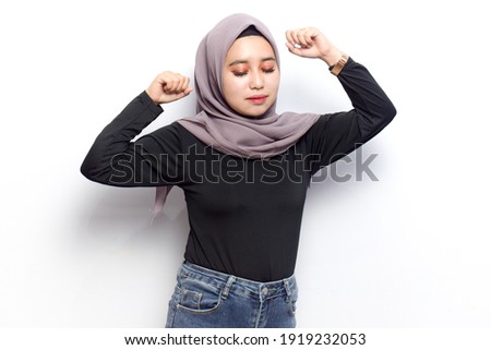 Dancing and Happy of of Young beautiful muslim asian women dress Veil(Hijab) and black shirt isolated on white background