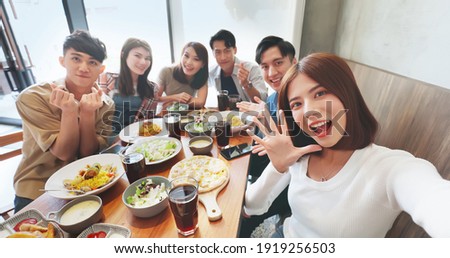 high angle shot of asian young six friends taking selfie in restaurant happily Royalty-Free Stock Photo #1919256503