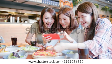asian young three females friends take the food picture happily in restaurant