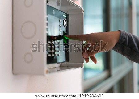 A hand using fingerprint scanner with the index finger for the identification or entering the door Royalty-Free Stock Photo #1919286605