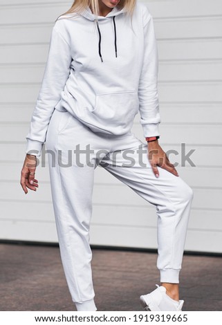 Young girl wears white fleece hoodie. Mockup for clothing line design and logo placement