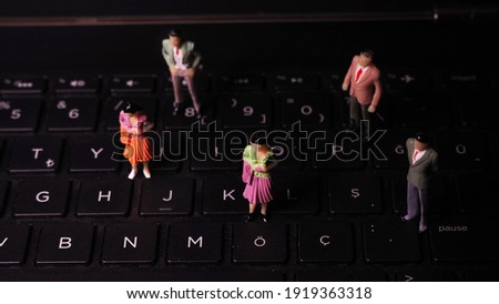 Miniature human models on notebook keyboard