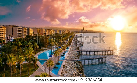 Sunset in Cyprus. The sun sets in the Mediterranean. Limassol at sunset. Evening panorama of Limassol with height. Mediterranean evening landscape. Holidays in Cyprus. Royalty-Free Stock Photo #1919366654