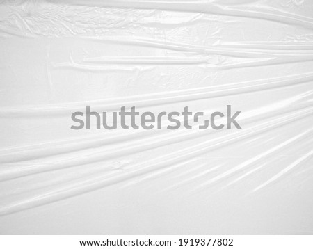 close up white wrinkled plastic sheet, opaque plastic with glossy finish texture for use as background for poster advertising Royalty-Free Stock Photo #1919377802