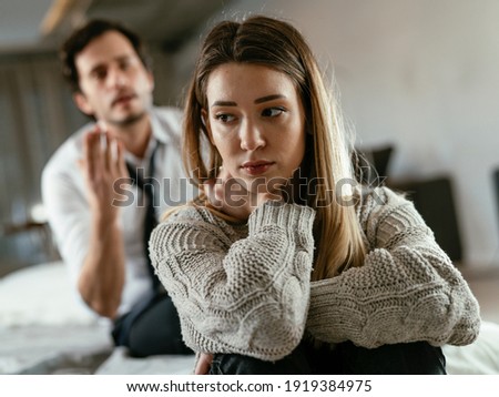 Husband and wife are arguing at home. Angry man is yelling at his wife.	