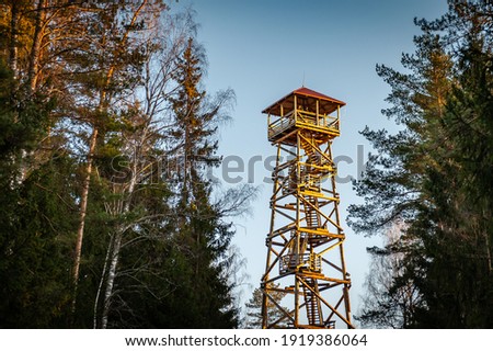 A viewing tower at the Blue Hills of Ogre. Latvia. Watchtower during sunset with trees.  Royalty-Free Stock Photo #1919386064