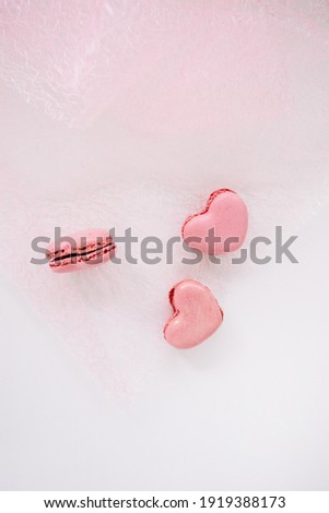 Pink macaroons on pink background for valentines day or a gift