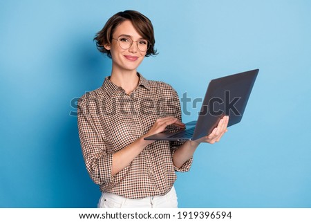 Photo of charming young person hands hold use laptop smile look camera isolated on blue color background