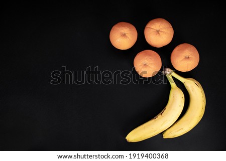 Orange and banana fruits with black background