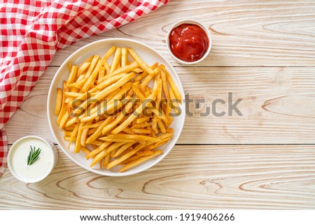 French fries or potato chips with sour cream and ketchup Royalty-Free Stock Photo #1919406266