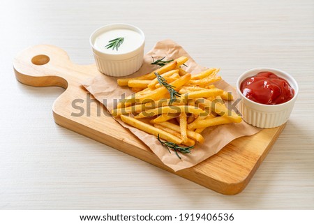 French fries or potato chips with sour cream and ketchup Royalty-Free Stock Photo #1919406536