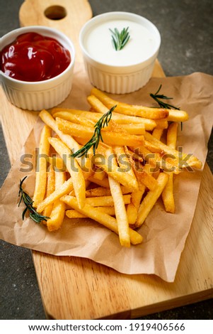 French fries or potato chips with sour cream and ketchup Royalty-Free Stock Photo #1919406566