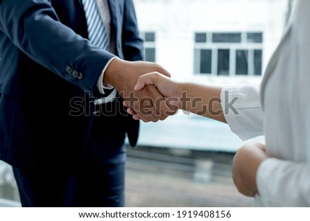 The businessmen shake hands after the meeting was successful and agreed upon. Royalty-Free Stock Photo #1919408156