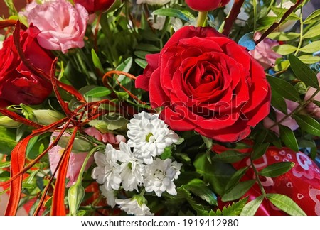 Bouquet of red roses, tulips, marigolds and carnations.