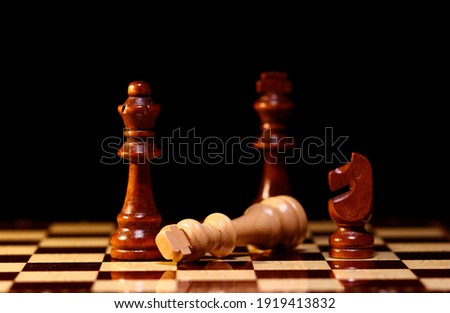 Chess pieces on a wooden chessboard