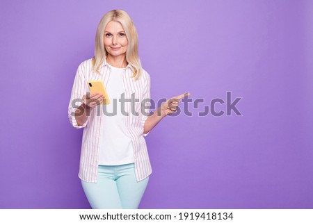 Photo of aged lady use telephone direct finger empty space novelty wear shirt isolated pastel purple color background