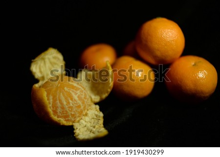 Fresh tangerines on a black blur background