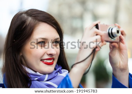 Woman with photocamera at travel destination background in autumn