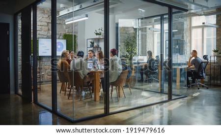 Diverse Group of Professional Businesspeople Meeting in the Modern Office Conference Room. Creative Team Discuss App Design, Analyze Data, Plan Marketing Strategy, Disrupt Social Media, Growth Hack Royalty-Free Stock Photo #1919479616