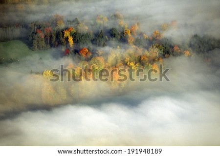 Aerial view of Morning fog and sunrise in autumn near Stowe, VT on Scenic Route 100