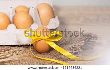 Easter Eggs with a Gold Ribbon on a Burlap on a Light background. Happy Easter concept banner. Copy space, Flat lay