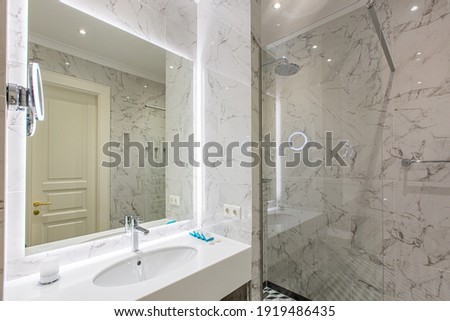 interior photo, bathroom with shower and white marble tiles