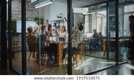 Two Owners of Promising Start-up Company Tell Good News to Diverse Team of Investors, Workers, Colleagues. Group of Multi Ethnic Business Professionals Celebrate Successful Product Release Royalty-Free Stock Photo #1919510075