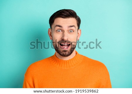 Photo of young excited man happy positive smile amazed excited shocked surprised news sale isolated over teal color background