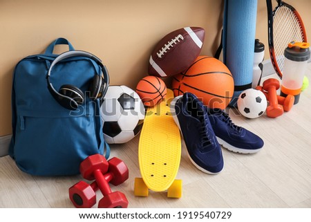 Set of sport equipment on floor near color wall Royalty-Free Stock Photo #1919540729