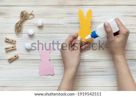 DIY Easter decor, step 5, paper Easter bunnies. High quality photo