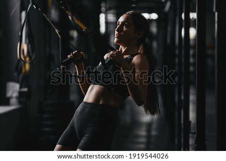 Fit young woman at a crossfit style on dark gray background. Fitness, functional, training, and lifestyle concept Royalty-Free Stock Photo #1919544026