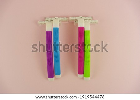 Colorful Razor Blades on Pink Background.