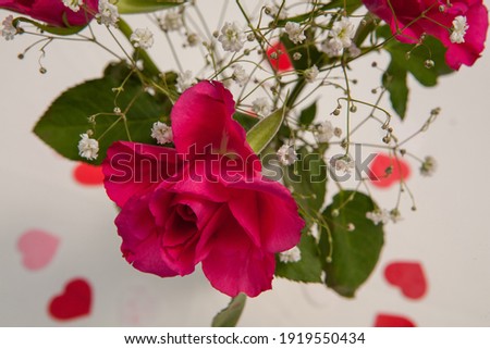 Close up of wedding bouquet of bridal flowers in hands of anonymous bride. Focus on fresh red flowers. High quality photo