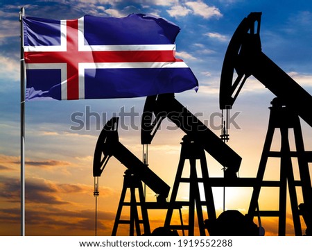 Oil rigs against the backdrop of the colorful sky and a flagpole with the flag of Iceland. The concept of oil production, minerals, development of new deposits.