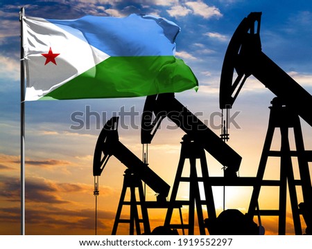 Oil rigs against the backdrop of the colorful sky and a flagpole with the flag of Djibouti. The concept of oil production, minerals, development of new deposits.