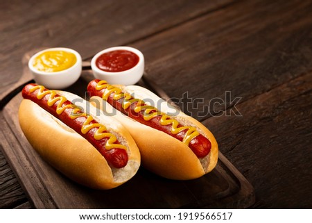 Hot dog with ketchup and yellow mustard. Royalty-Free Stock Photo #1919566517