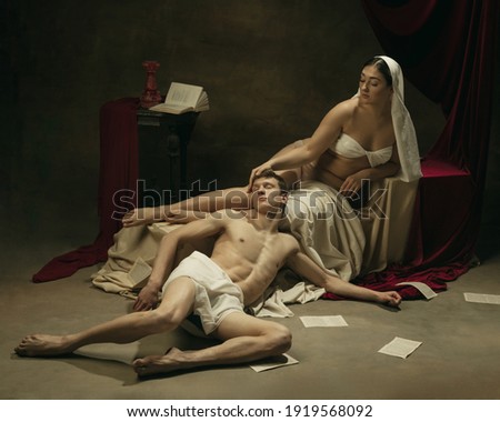 Falling in love. Modern remake of classical artwork - young medieval couple on dark background, golden colored. Concept of art, creativity, comparison of eras, history, modernity and renaissance.