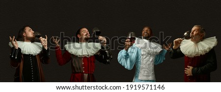 Enjoying luxury red wine. Medieval men as a royalty persons in vintage clothing on dark background. Concept of comparison of eras, modernity and renaissance, baroque style. Creative collage. Flyer Royalty-Free Stock Photo #1919571146