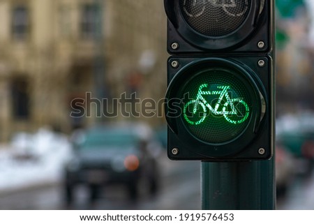 Sustainable transport. Bicycle traffic signal, green light, road bike, free bike zone or area, bike sharing, close up with street and car on background Royalty-Free Stock Photo #1919576453