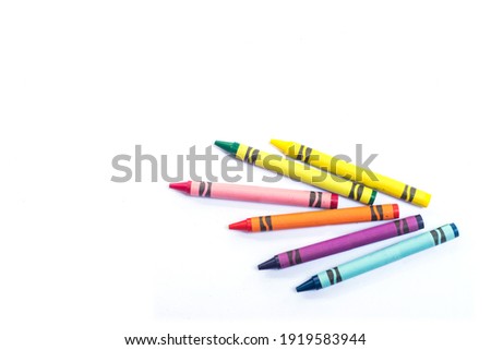 Multicolored Crayons and pastels lying in chaos isolated on white background with copy space. Royalty-Free Stock Photo #1919583944