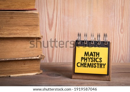 Math Physics Chemistry. Stack of books and a notebook on a shelf. 