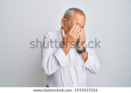 Handsome senior man wearing casual white shirt rubbing eyes for fatigue and headache, sleepy and tired expression. vision problem 