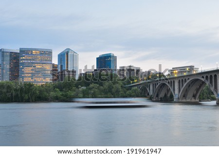 Washington DC - Key Bridge, Rosslyn and tourist boat in Potomac River in the eveniing