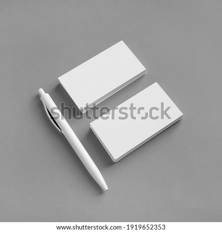 White stationery set. Business brand template on gray paper background. Blank business cards and pen.