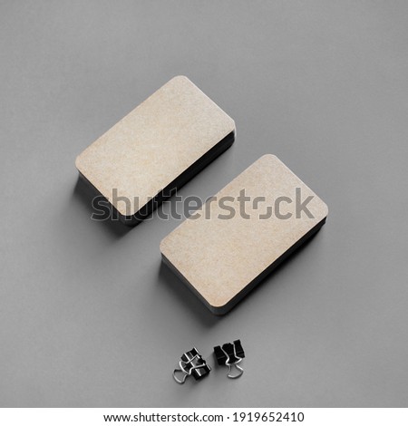 Brown paper business cards on gray background. Mockup for branding identity.