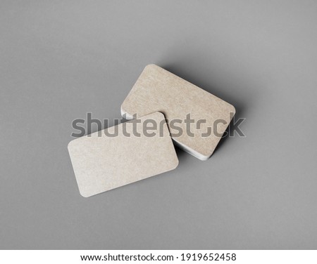 Blank kraft business cards template on gray paper background. Template for graphic designers portfolios.