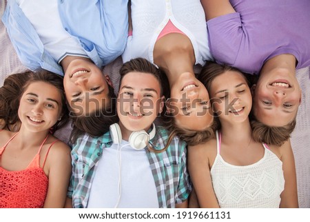 funny portrait of group of teenagers spending time together