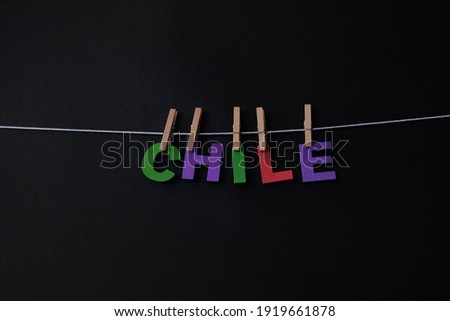 Word Chile on black background. The Republic of Chile is a country in western South America. It occupies a long, narrow strip of land between the Andes to the east and the Pacific Ocean to the west.